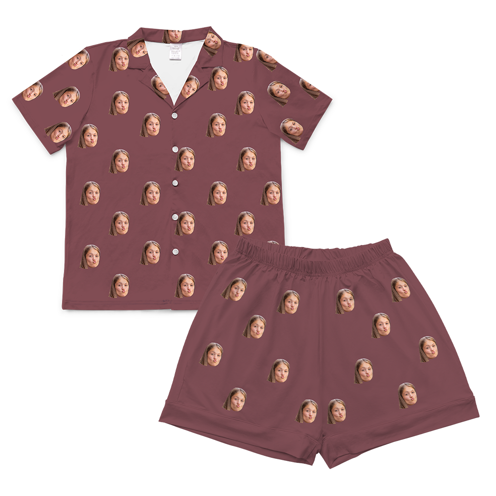 A two-piece set of short-sleeve pajamas in a solid maroon or dusty rose color. The pajamas are customized with multiple small, repeating images of a young woman's face, making a slightly pouting or kissy face expression.