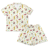 A two-piece kids' pajama set featuring a short-sleeve button-up shirt and matching shorts, both printed with a festive holiday theme including Santa Claus, Christmas trees, hot air balloons, and the word 'Merry' on a white background.[ShortSleevePjs_Set_kids]