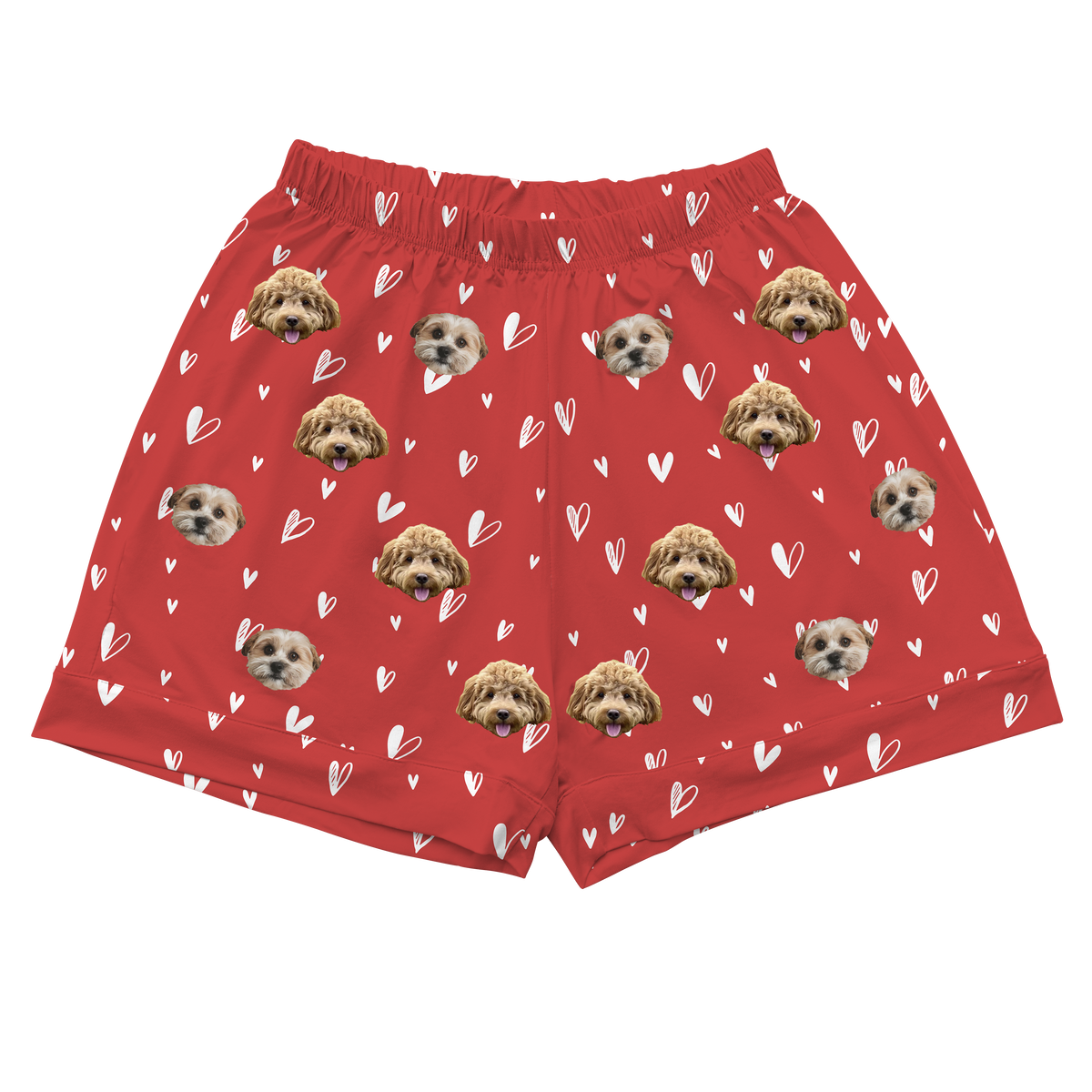 A pair of short pajama shorts in a vibrant red color with an elastic waistband. The shorts are patterned with small, white, hand-drawn outline hearts. The main motif is a repeating pattern of small, cropped photos of two different dogs' faces.