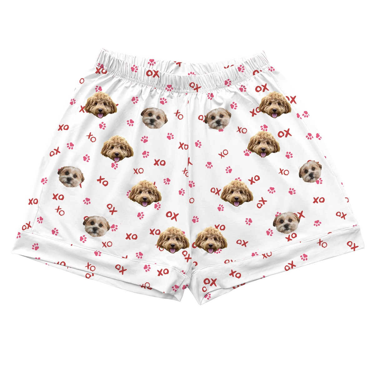 White pajama shorts with an elastic waistband, featuring an all-over print of two dog faces, red paw prints, and red “XO” lettering.