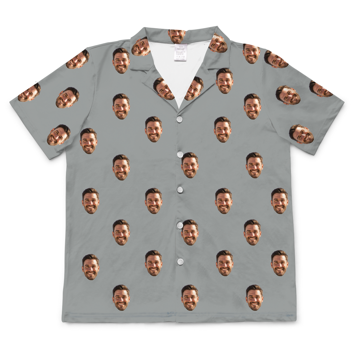 Gray short-sleeve button-up shirt featuring a repeating pattern of the same smiling man's face printed across the entire fabric.
