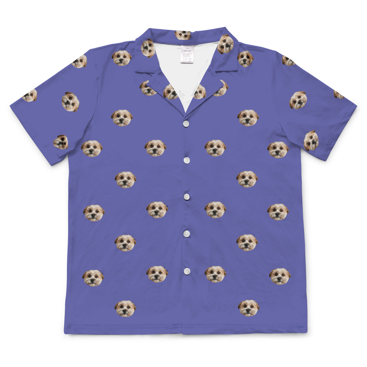 A short-sleeve, button-down pajama top in a grape color (medium purple). It features an all-over repeating pattern of a single small, fluffy dog's face, scattered randomly across the fabric.
