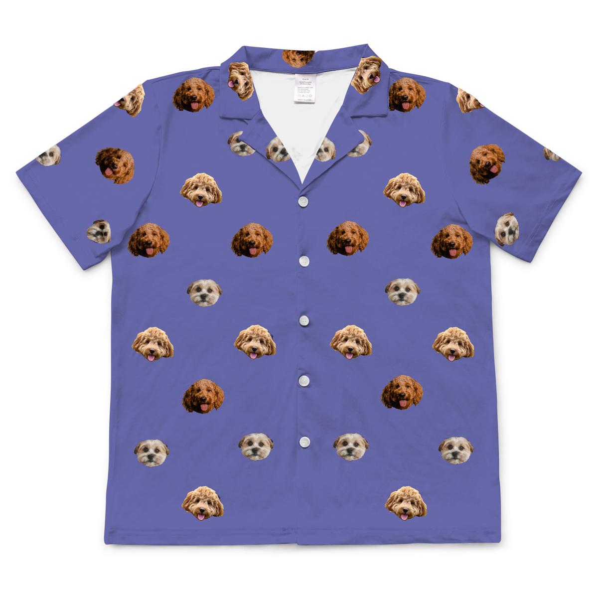 A single short-sleeve, collared, button-down pajama shirt in a deep grape purple color. The fabric features a repeating pattern of small, cropped photos of three different dogs' faces.