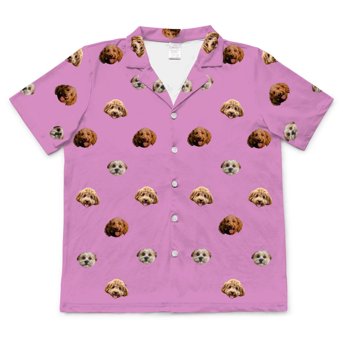 A short-sleeve, button-down pajama top in an orchid color. It features an all-over repeating pattern of the faces of three different small dogs.
