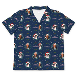 A navy blue short-sleeve button-up camp shirt with a repeating Christmas-themed print featuring dog portraits wearing Santa hats, surrounded by green wreaths, white snowflakes, and the text 'CANDID CROWNS'.