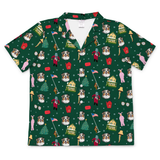 A short-sleeve green holiday-themed medical scrub shirt featuring a repeating pattern of Australian Shepherd dogs, Christmas trees, Santa Claus, mailers, and houses on a white background.