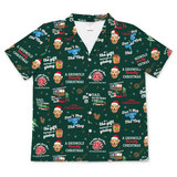 A short-sleeve button-front camp collar shirt in dark green with an all-over Christmas print featuring a man's face, Santa hats, gifts, Christmas trees, and text including 'A Griswold Christmas' and 'Don't Trog The Nog'.