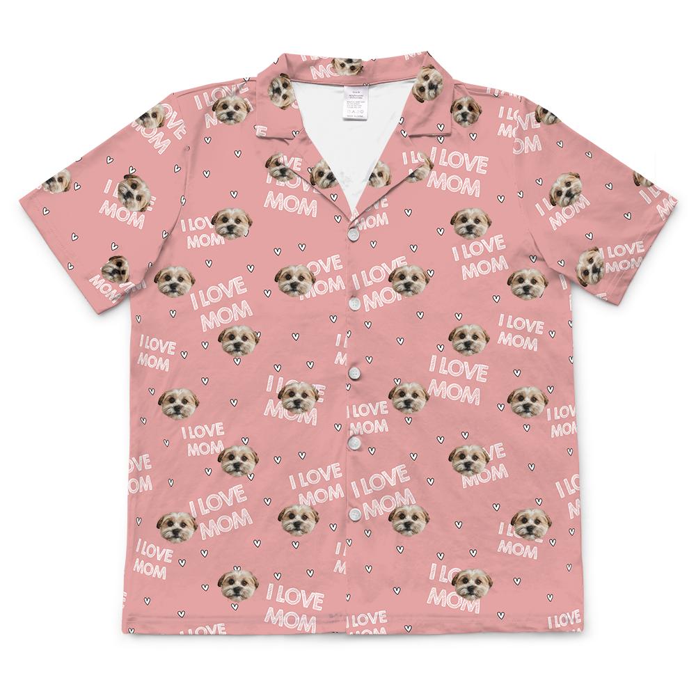 Short-sleeve, button-down pajama top in light pink, featuring a repeating pattern of a single dog face, small hearts, and the text "I LOVE MOM."
