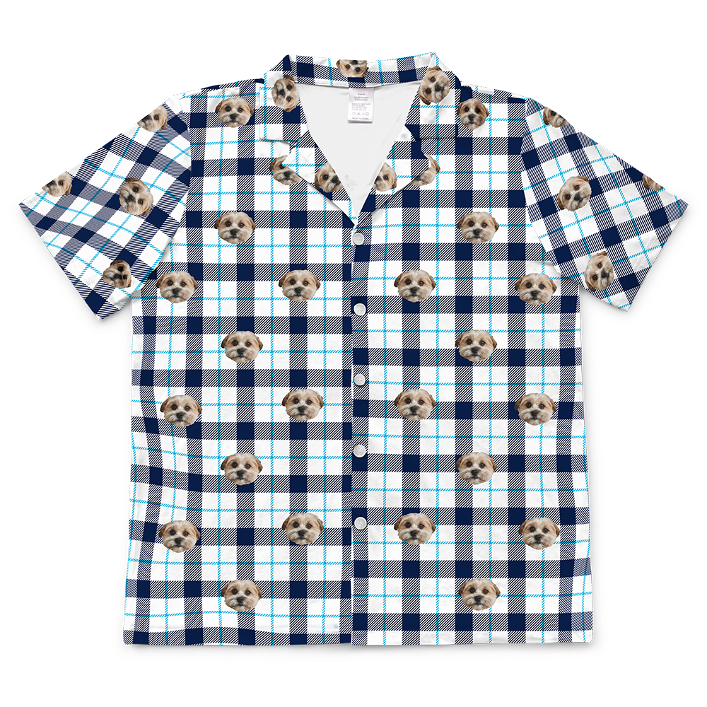 Blue and white plaid short-sleeve button-down pajama top featuring an all-over pattern of a single dog’s face.