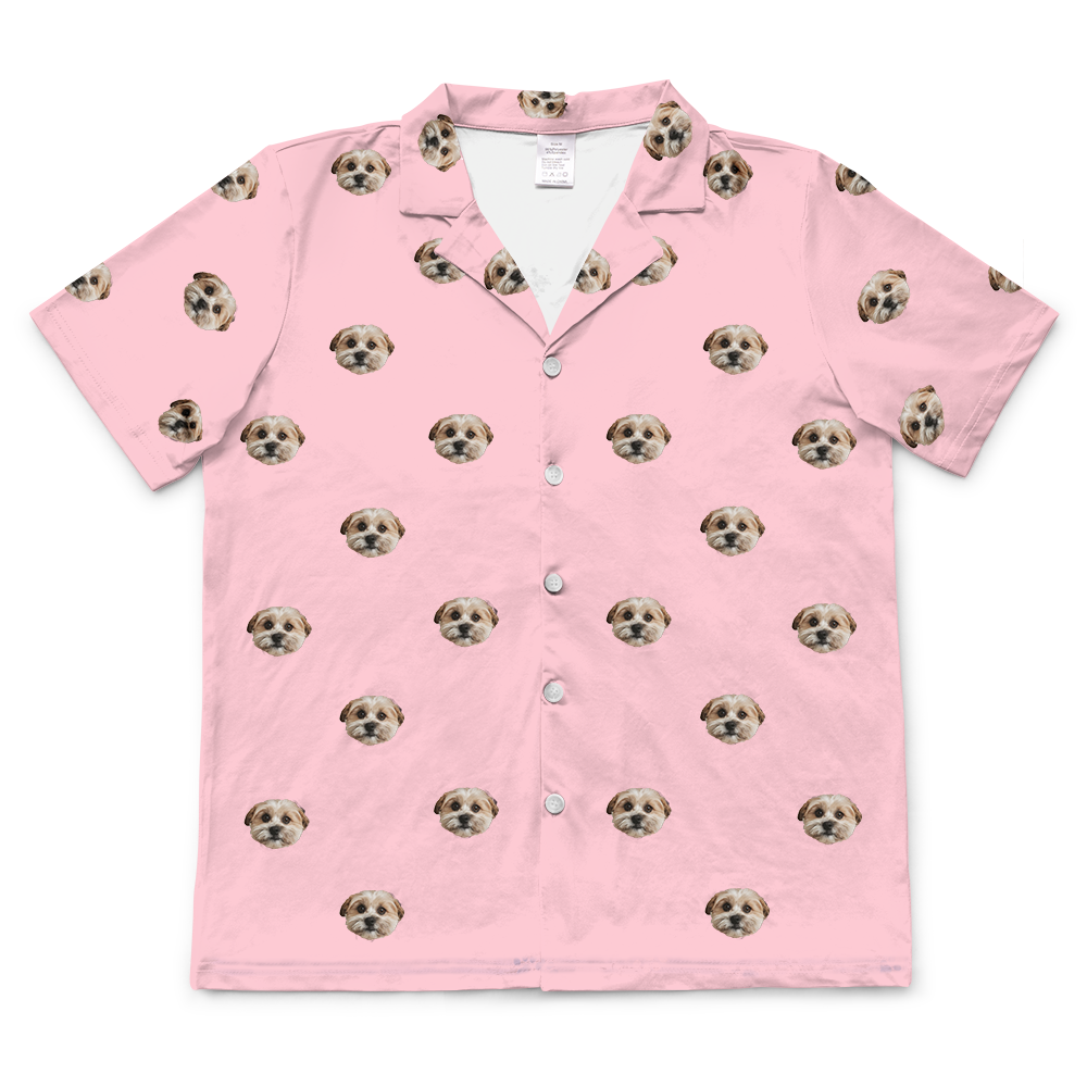 Pink short-sleeve pajama shirt with a repeating pattern of a single dog’s face.