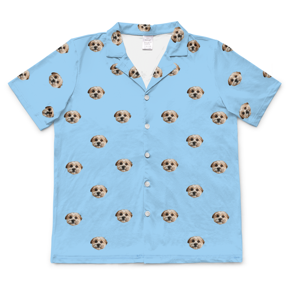 Sky-blue short-sleeve button-up pajama top with an all-over pattern of a small beige dog’s face.