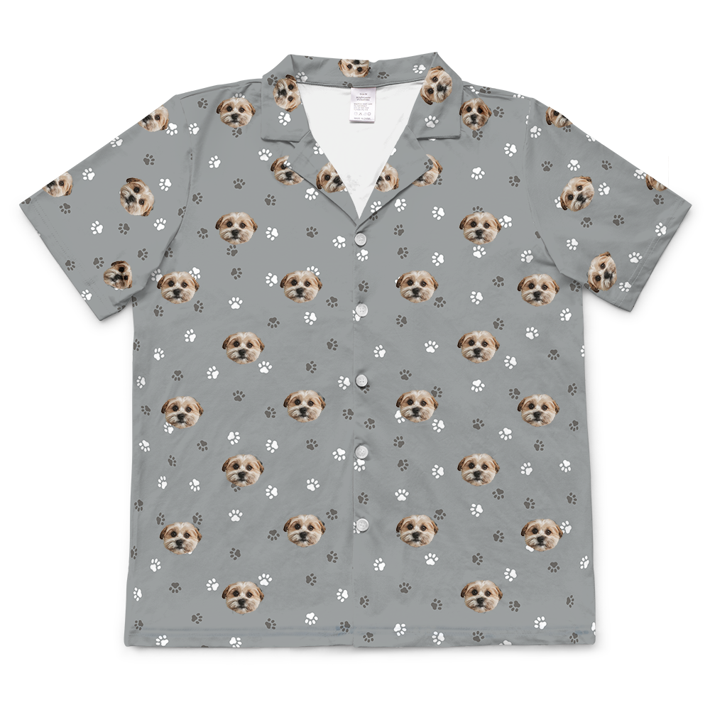 Slate gray short-sleeve pajama top with a collar and buttons down the front, featuring an all-over repeating pattern of a small dog's face.