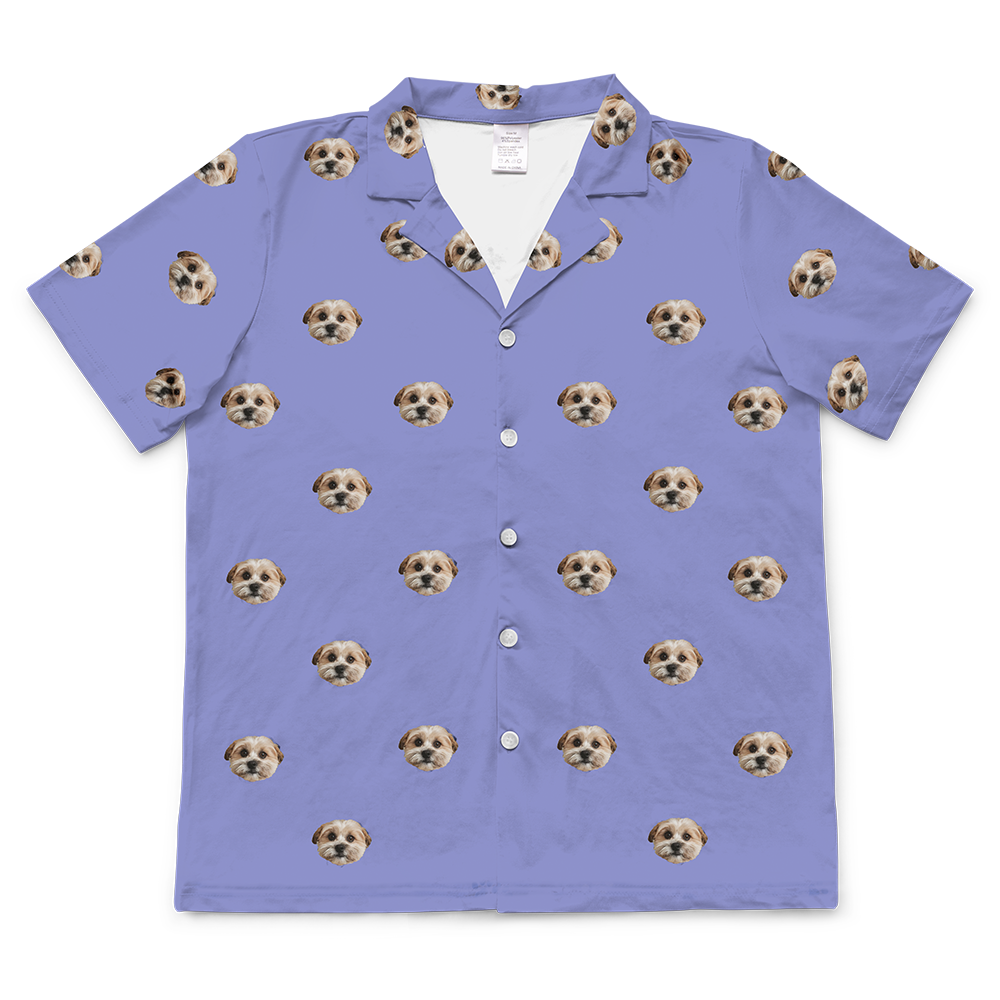 Periwinkle blue short-sleeve button-down pajama top patterned with the custom photo head of a single, light-colored dog.