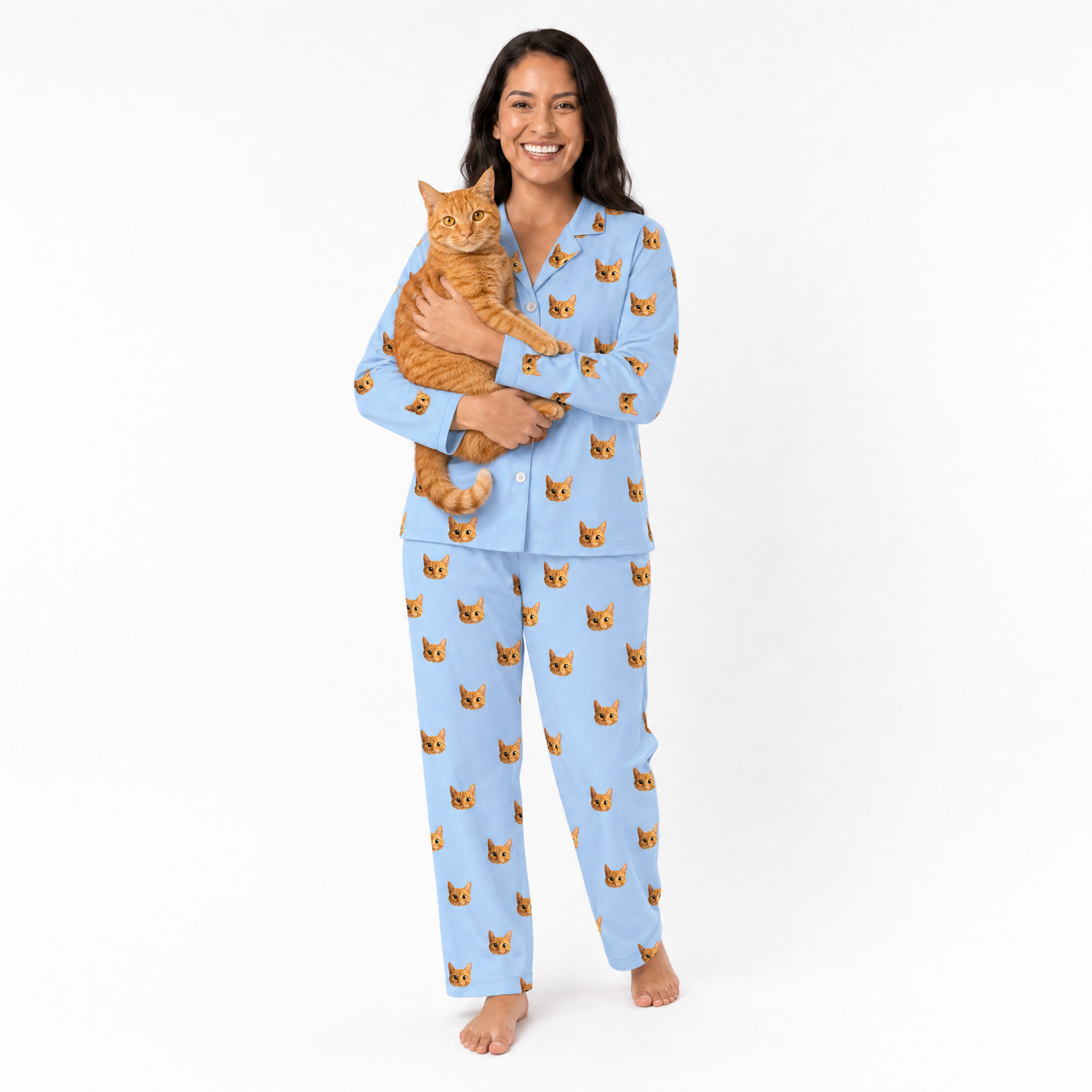 Woman wearing sky blue pajamas with cat pattern, holding an orange cat on a white background