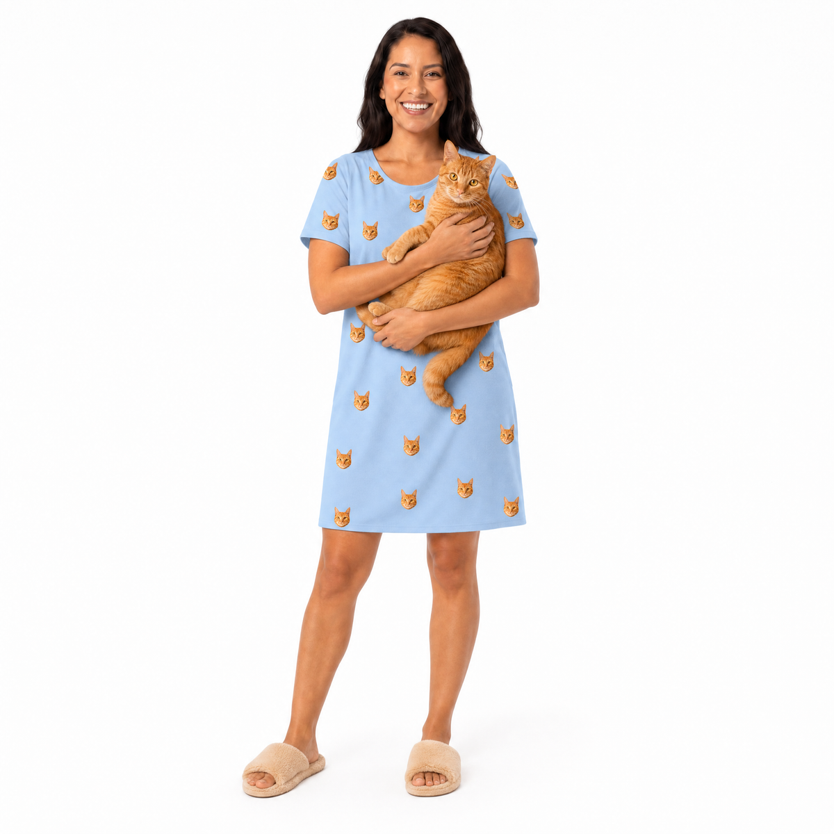 Woman wearing a sky blue nightgown with cat patterns, holding an orange cat on a white background