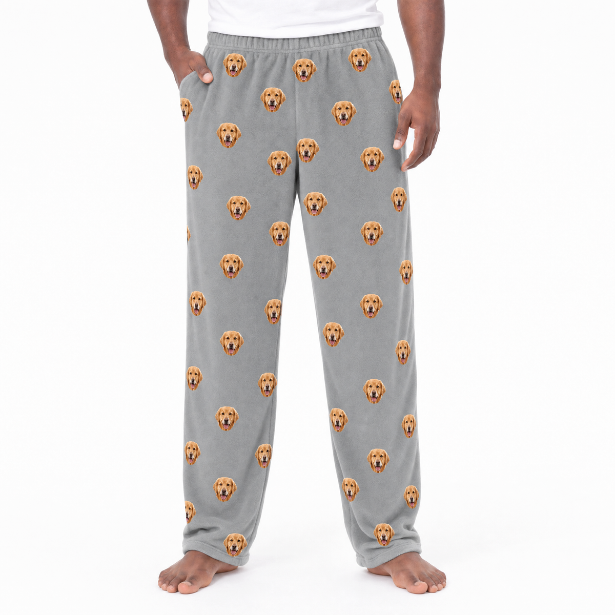 Gray pajama pants with dog pattern worn by a person on a white background