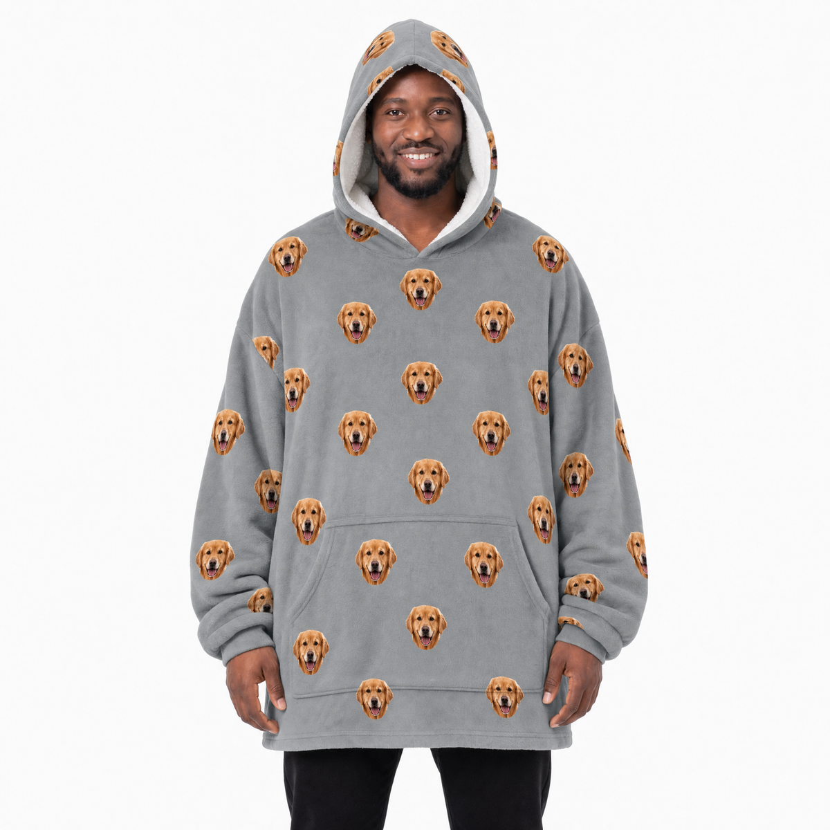 Person wearing a gray blanket hoodie with dog pattern on a white background