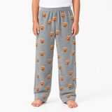 Gray pajama pants with dog face pattern worn by a person on a white background
