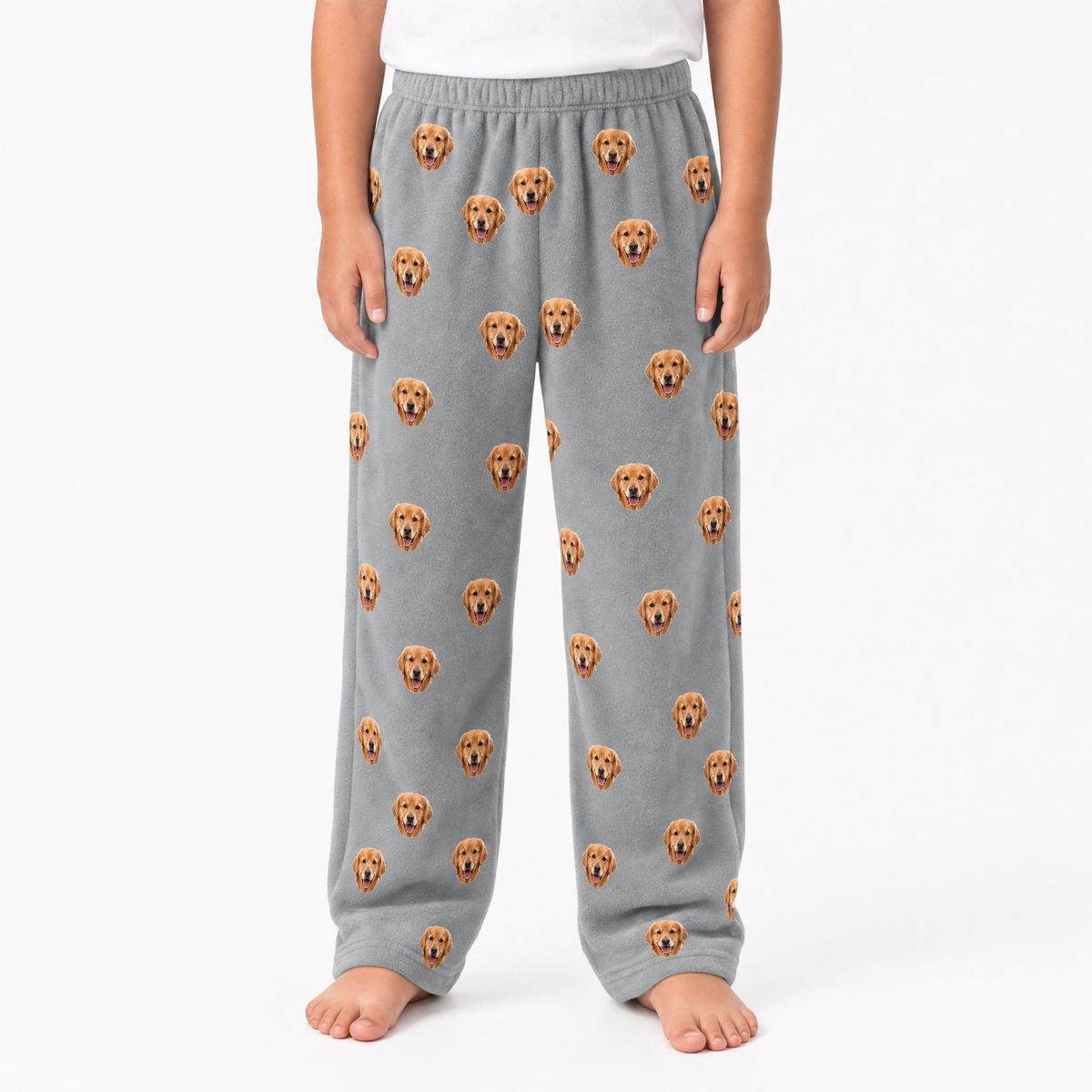Gray pajama pants with dog face pattern worn by a person on a white background