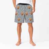Person wearing gray shorts with dog pattern on a white background