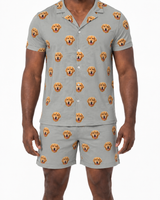 Man wearing a gray pajama set with dog face pattern on a white background