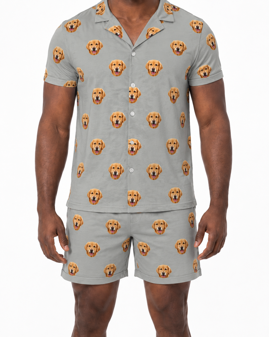Man wearing a gray pajama set with dog face pattern on a white background