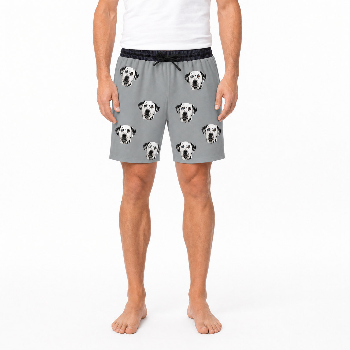 Person wearing gray shorts with Dalmatian dog pattern on a white background