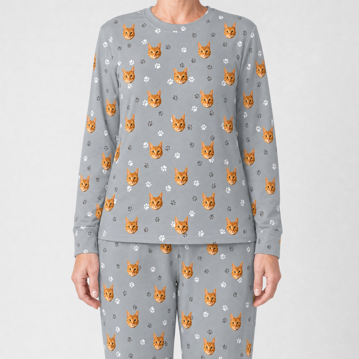 Gray jogger pajama set with cat pattern on a plain background