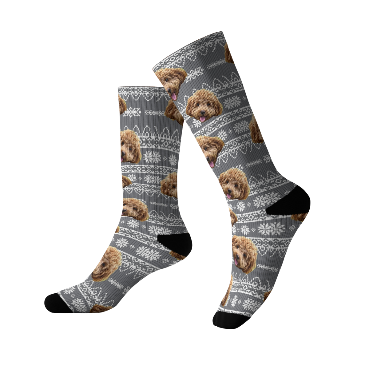 Gray socks featuring a repeating pattern of a fluffy brown dog’s face over a white holiday sweater–style design with snowflakes and decorative knit patterns. The socks have black toes and heels.