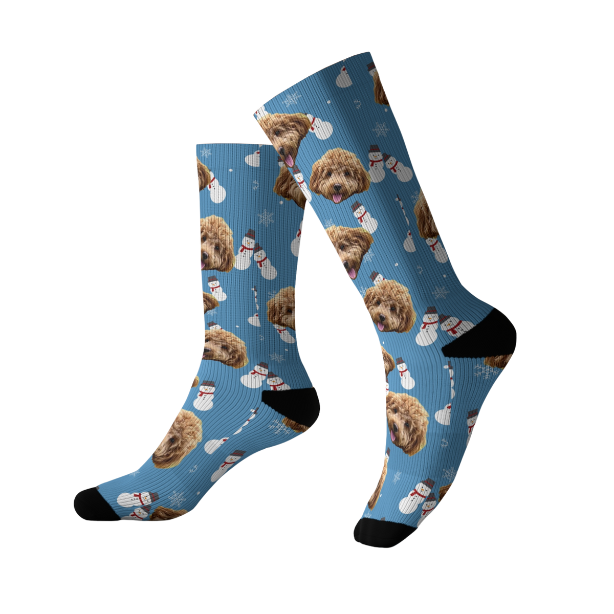 Blue crew socks decorated with repeating images of a curly-haired brown dog’s face, snowmen, and snowflakes, with black heels and toes.
