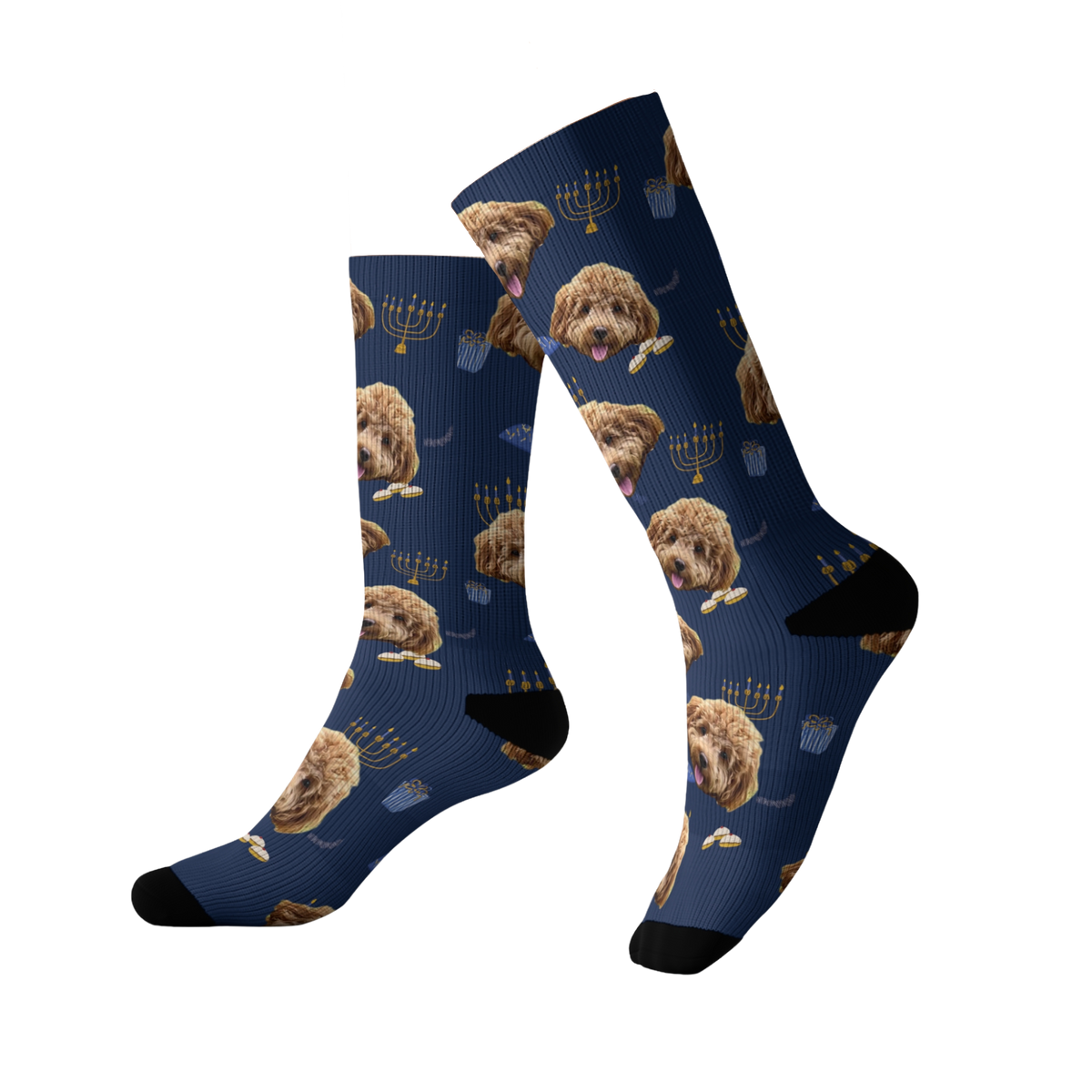 Dark blue crew socks featuring repeating images of a curly-haired brown dog’s face along with Hanukkah-themed icons, with black heels and toes.