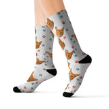 White custom pet-face socks featuring a repeating orange cat print with red and green paw prints and black toes and heels[ChristmasPaws]