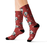 Red custom pet-face socks featuring a repeating black and white dog print with paw prints and black toes and heels[RedPaws]