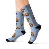 Light blue custom pet-face socks featuring a repeating curly-haired dog print with white snowflakes and black toes and heels[Snowflakes]