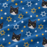 Close-up of the Star of David print showing custom pet faces with gold and white Stars of David on a blue fabric