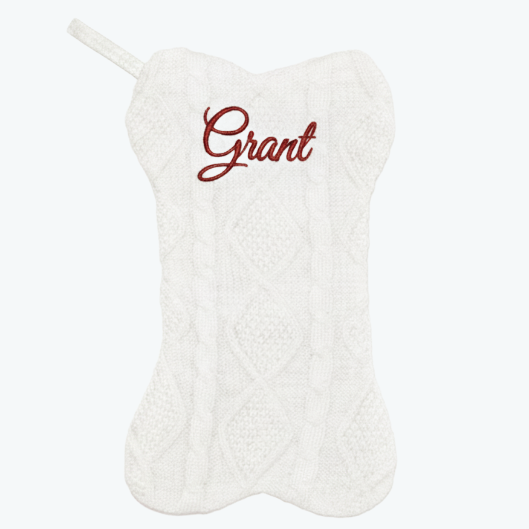 White cable knit dog-bone stocking with red 'Grant' name & hanging loop.