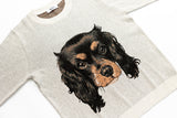 A light heather gray knit sweater featuring a large, detailed graphic print of a black and tan dog's head on the front.