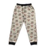Superman-themed pajama pants with logos and characters on a blue background
