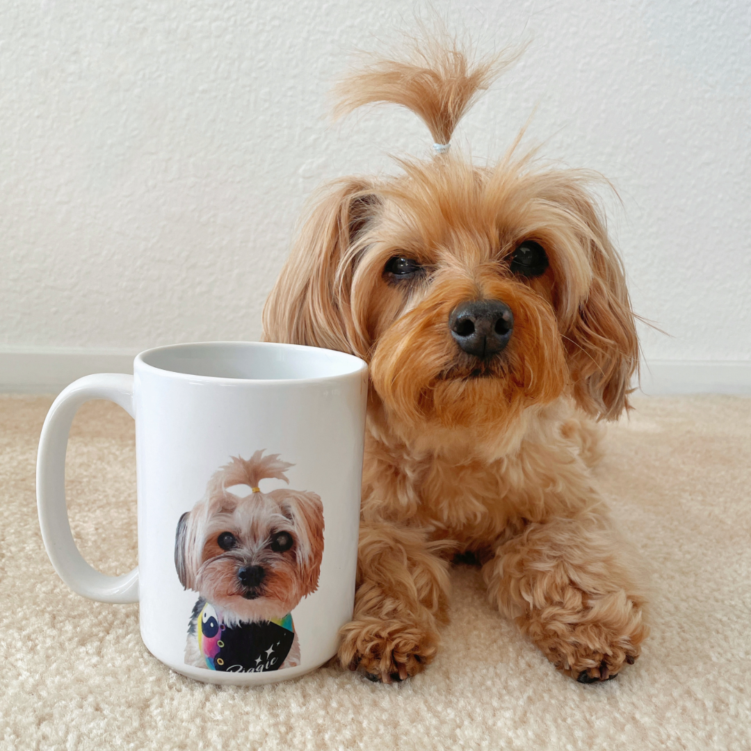 Dog sitting next to a mug with a dog's face printed on it
