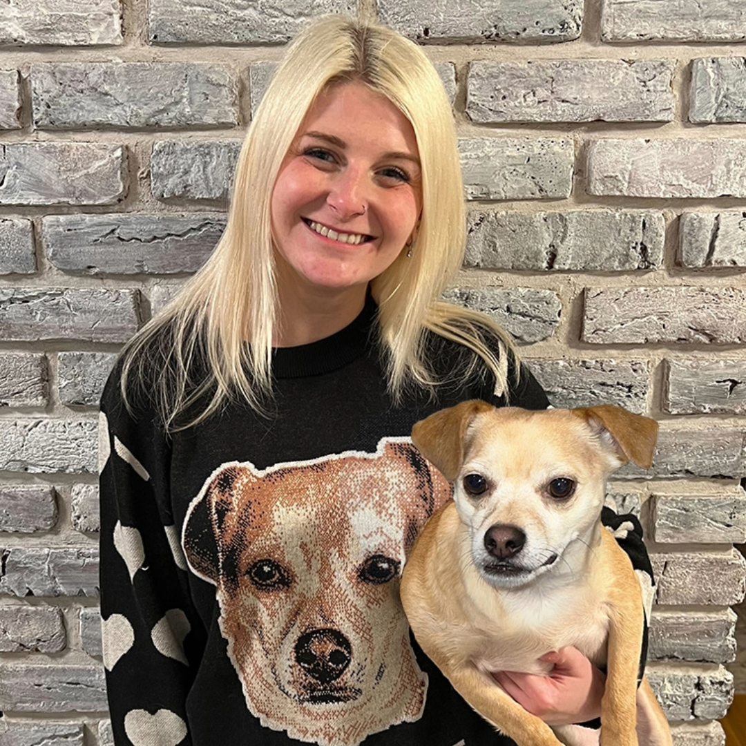 Woman with custom knit sweater next to her dog