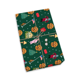 A rectangular gift box wrapped in dark green holiday-themed paper with a pattern of golden retriever dogs, Christmas trees, Santa Claus, and snowflakes, tied with a brown string on a white background
[ChristmasStory]