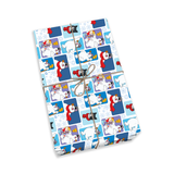 A gift-wrapped package tied with twine, shown at an angle on a clean white background. The wrapping paper has a repeating winter-themed cartoon pattern with polar bears, snowflakes, and blue panels.
