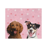 Pink blanket with paws featuring the illustrations of two dogs.
