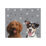 Gray blanket with paws featuring the illustrations of two dogs.