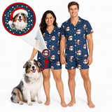 A man and a woman wearing matching navy blue Christmas pajama sets with a dog print and Santa hat motif, standing barefoot on a white background. A circular inset shows a dog wearing a Santa hat, and arrows point from the inset to the couple's pajamas, indicating a dog-themed matching sleepwear product.