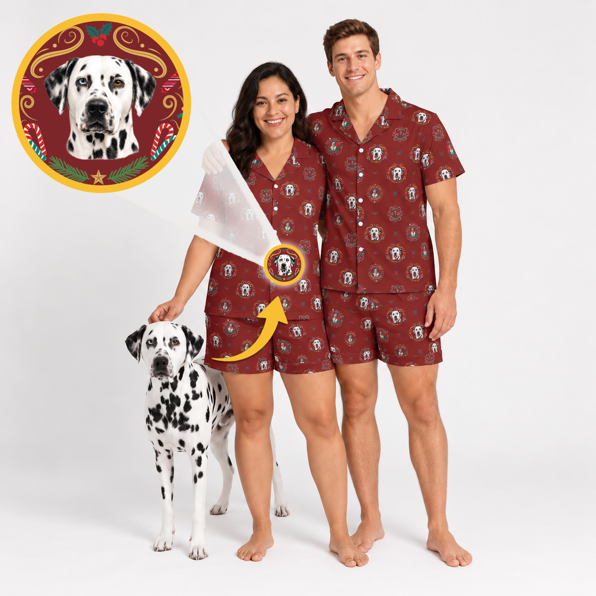 A man and a woman wearing matching burgundy short-sleeve pajama sets with a Dalmatian dog print, standing barefoot on a white studio background next to a Dalmatian dog. A circular inset at the top left shows a close-up of the printed dog motif, and a yellow arrow points from the inset to the pattern on the pajamas.