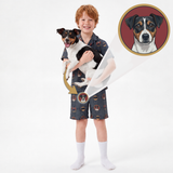 A young boy wearing a custom printed dog-themed pajama set (short-sleeve button-up shirt and shorts) holds a Jack Russell Terrier. An inset circle in the top right shows the original reference dog portrait used for the custom print.