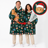 A man and a woman wearing matching green Christmas-themed hooded robes with a printed cat pattern, standing against a white studio background. The man holds an orange tabby cat, and a circular inset at the top right shows a close-up of a cat wearing a Santa hat.