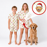 Two children wearing matching custom-printed pajama sets stand barefoot on a white studio background next to a golden retriever. An inset circle at the top right shows a dog portrait wearing a Santa hat, with arrows pointing to the children's pajamas to demonstrate personalization.