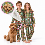 Two children wearing matching green plaid pajamas with a dog print, standing barefoot on a white background next to a fluffy brown dog. A circular inset shows a custom dog face design that appears in the pajama print, with a pink arrow indicating the customization.